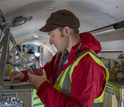 Inside the G-V: Scientist Eric Morgan with air samples taken above South America.